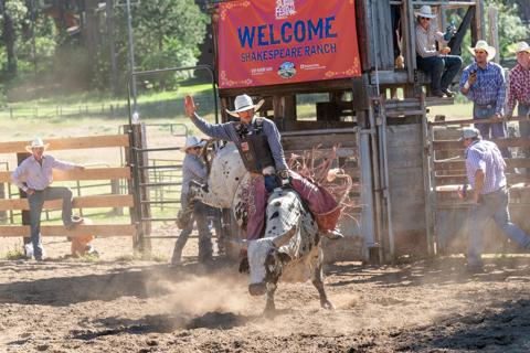 A rodeo participant rides a horse at Shakespeare Ranch.