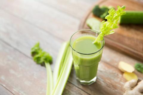 Glass of celery juice with stalk garnish