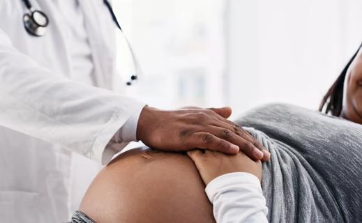 Photo of a pregnant woman and her doctor