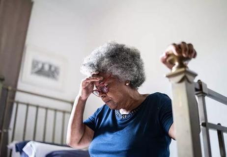 Elder woman hand to head in pain from a headache