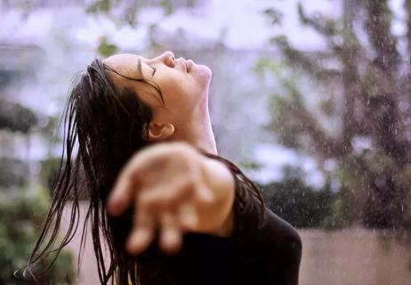 woman with wet hair outside during rainstorm