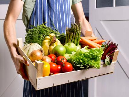 Man delivering fruit and vegetable box.