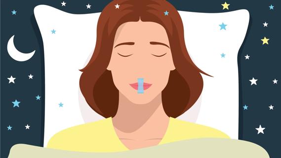 Person asleep in bed at night with a strip of mouth tape over their mouth