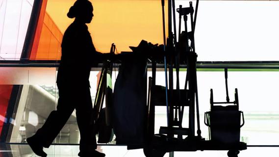 Silhouette of custodian with cleaning cart