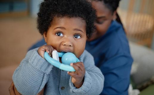 Baby chewing on teething ring