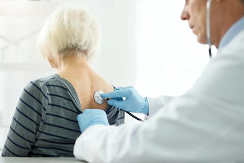 Doctor listening to patient with stethoscope