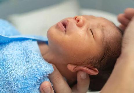 newborn being dried off after a bath