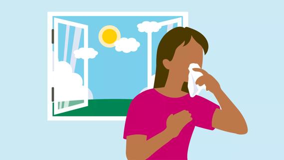 Person coughing into a tissue by window during sunny, summer day
