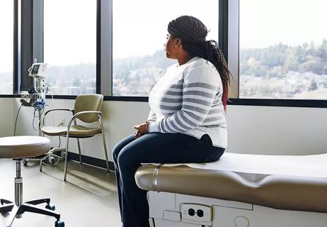 worried woman alone in hospital room