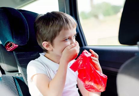 child suffering from motion sickness in car