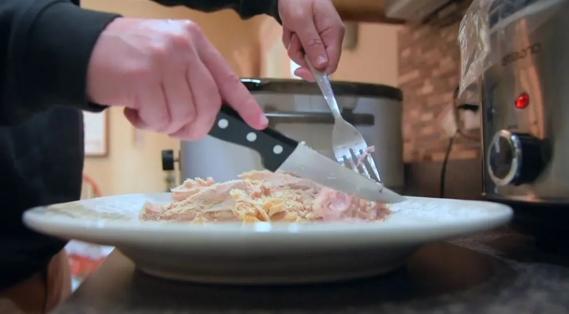 Person cutting turkey on plate