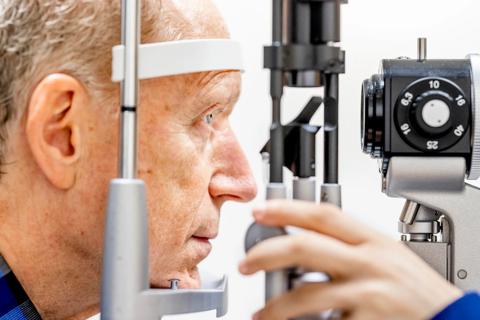 Eye doctor looking into a man's eye