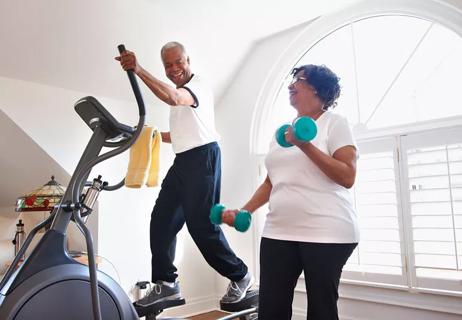 elderly husband and wife exercise at home