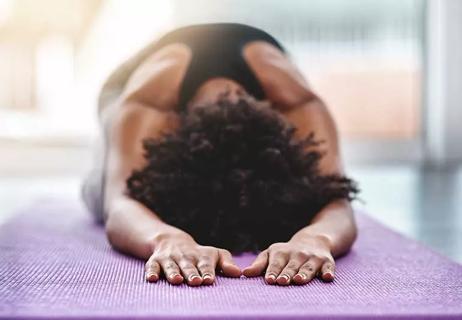 person doing child's pose in yoga class