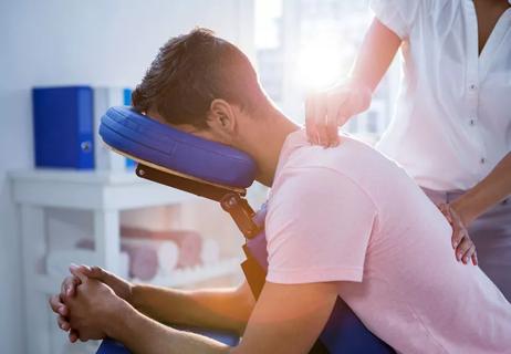 man receiving chair massage therapy