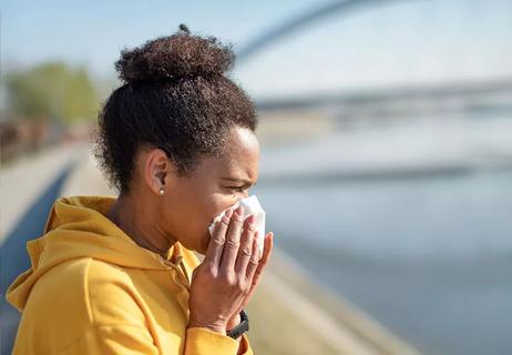 A person using a tissue to blow their nose