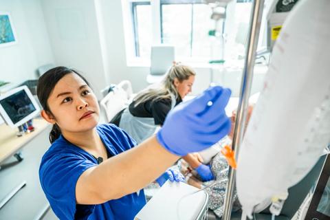 Nurse adjusting IV