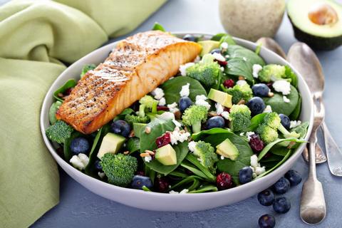 Spinach salad with avocado, blueberries, broccoli, cranberries and seared salmon