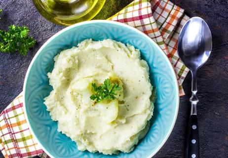 Bowl of mashed cauliflower in blue bowl