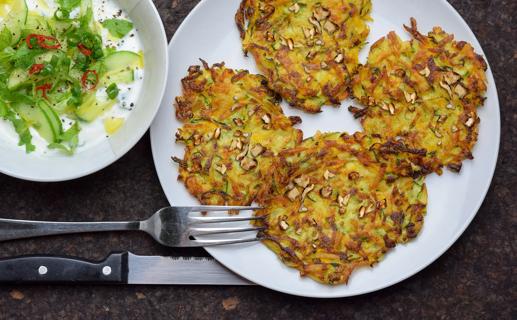 Plated walnut, zucchini and potato pancakes, with greens and apple side salad