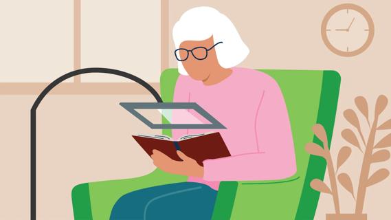Older person reading using a magnifying reader