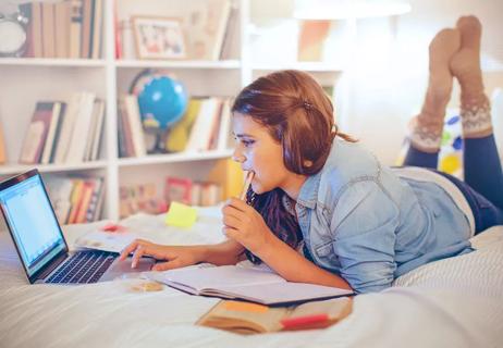Teen studying in her bedroom