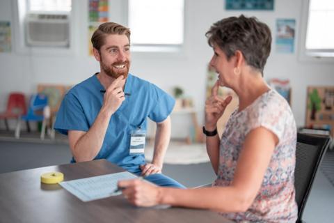 Speech therapist working with older patient