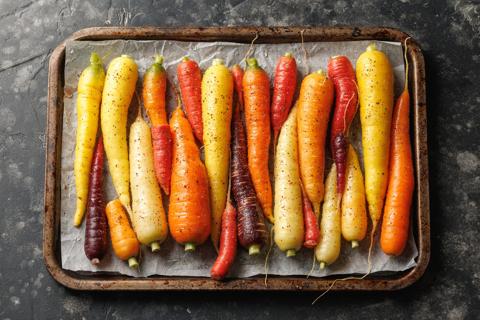 Baked whole rainbow carrots on a baking tray