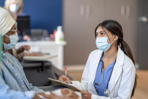 Doctor Talking With a Cancer Patient During Treatment