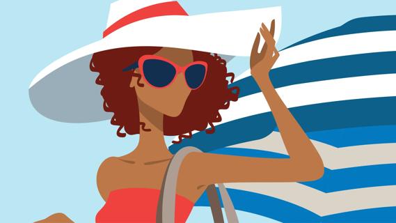 Person wearing sunglasses and wide-brimmed hat, with beach umbrella nearby