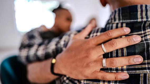 Person hugging in support group