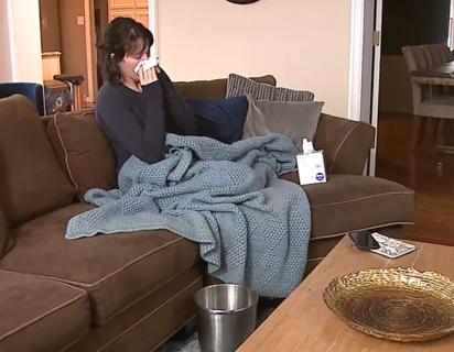 Woman sick on couch