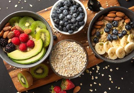Carbohydrate food including oats, fruits and nuts all combined into a healthy breakfast.