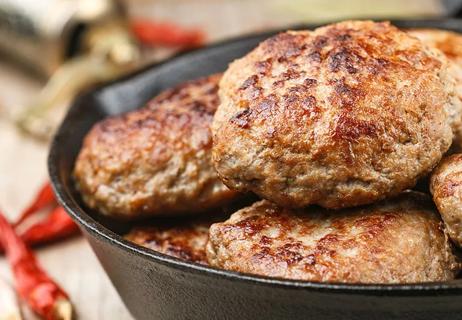 Turkey patties in a cast-iron skillet