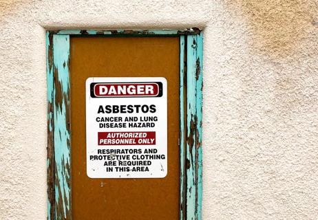 building with asbestos warning posted