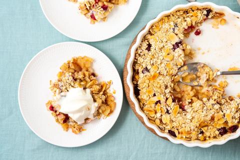 Two serving plates with winter fruit gratin, with serving dish