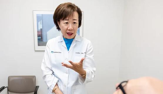 doctor taking pulse of a woman in an exam room