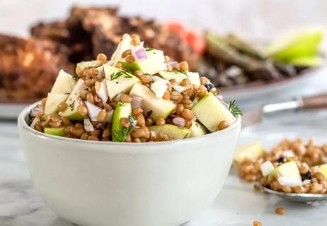 Wheat berry salad in white bowl