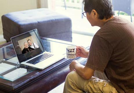 man having virtual visit with friends