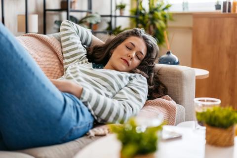 Woman napping on the couch during the day