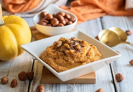 Bowl of sweet potato pumpkin banana mousse on a table decorated for fall