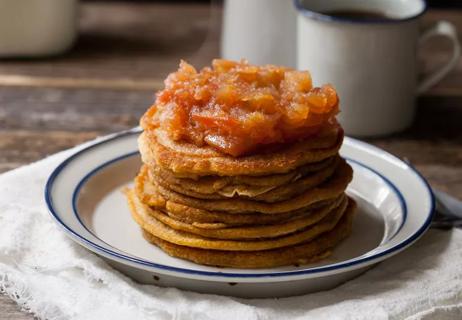 Stack of pumpkin pancakes topped with apple butter