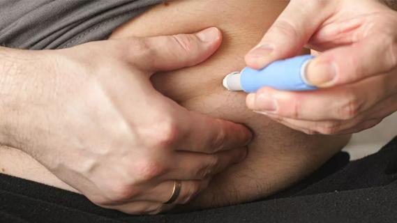 Photo of patient injecting drug into stomach