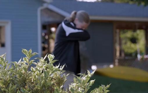 Woman sneezing outside