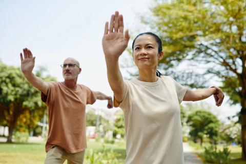 People doing tai chi in a park