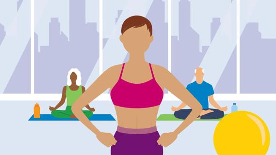 People sitting on yoga mats taking a class, with the instructor up front