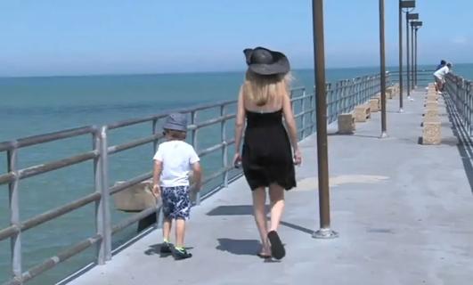 Woman walking down pier