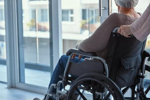 older women being pushed in wheelchair in hospital
