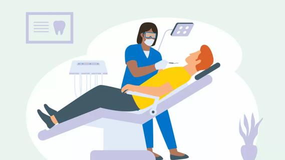 Red-headed patient in dental chair in dentist office with healthcare provider