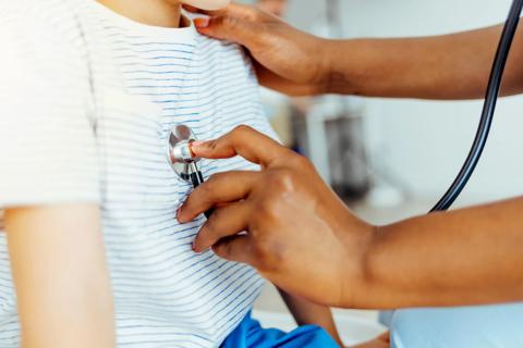 clinician holds stethoscope on child's chest